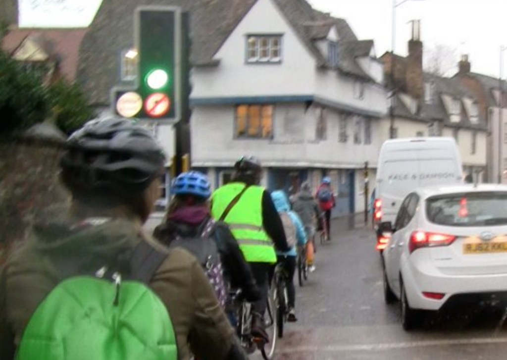 Cambridge cycling, image of motor vehicles next to cyclists. 