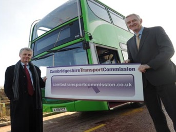 Cambridge Transport Commission - Banner being held by commissioners in front of a bus