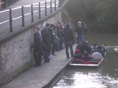 photo of people on the quay next to a boat