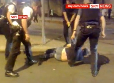 UK Police shock a man in Nottingham with a TASER while he is lying on the ground surrounded by four officers.