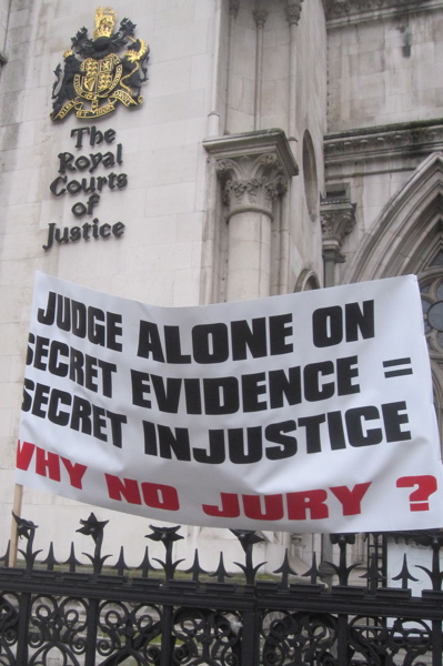 Supporters of the defendants in the UK's first modern criminal trial without a jury placed banners on the railings outside the Royal Courts of Justice.